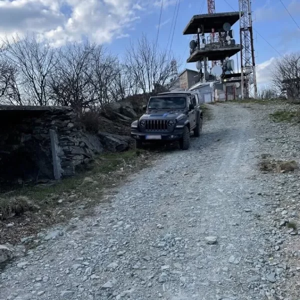 Off-road Jeep ride down the mountain from the satellite tower,on a road strewn with crushed rocks.