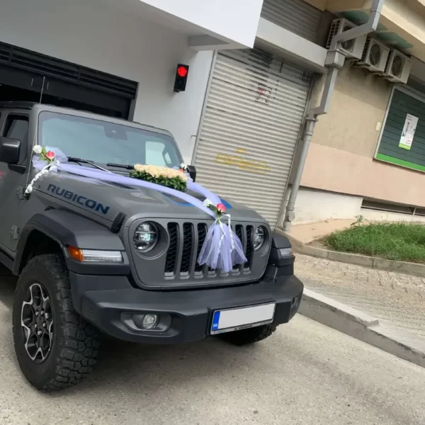 A decorated Jeep pulls out of the garage.